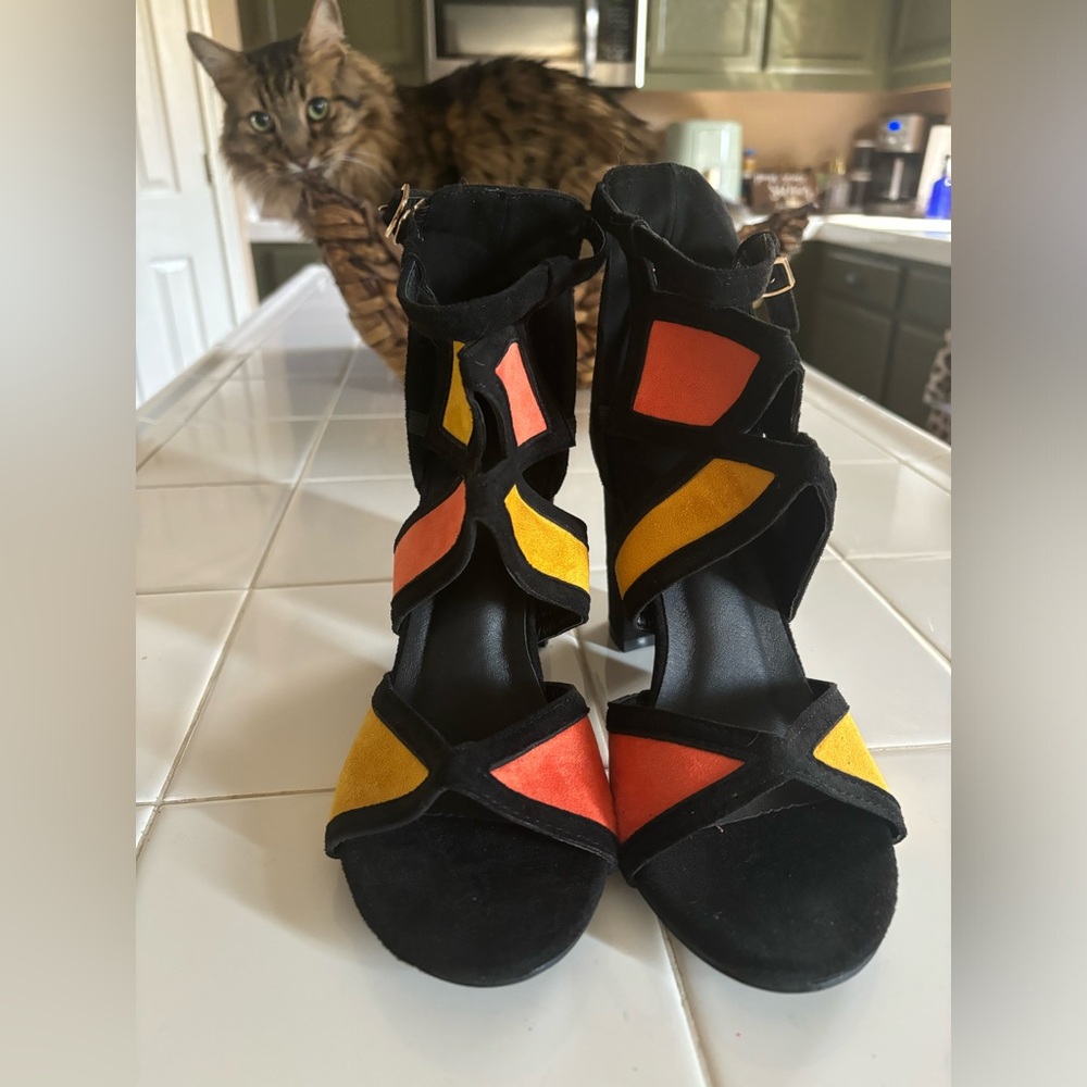 Brand new sassy heels ! Great colors and unique design .